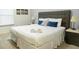 King-size bed with neutral bedding and nightstand in bedroom at 3211 Gold Ln, Kissimmee, FL 34747