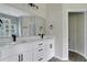 Modern bathroom with white double vanity and a large mirror at 556 Marion Oaks Pass, Ocala, FL 34473