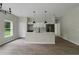 Modern kitchen with white cabinets, an island, and black pendant lighting at 556 Marion Oaks Pass, Ocala, FL 34473