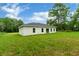 Single-story house with gray roof and large backyard at 556 Marion Oaks Pass, Ocala, FL 34473