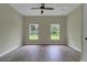 Spacious bedroom with two windows and wood-look tile flooring at 556 Marion Oaks Pass, Ocala, FL 34473