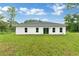 Single-story house with gray roof and large backyard at 556 Marion Oaks Pass, Ocala, FL 34473
