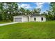 Newly constructed home with gray garage door and expansive lawn at 556 Marion Oaks Pass, Ocala, FL 34473