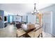 Bright dining area with a wooden table and seating for six, adjacent to a living room at 11932 Old Glory Dr, Orlando, FL 32837