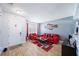Living room with red couches, coffee table, and wood-look floors at 11932 Old Glory Dr, Orlando, FL 32837