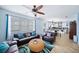 Spacious living room with leather sofas, a coffee table, and view of kitchen at 11932 Old Glory Dr, Orlando, FL 32837