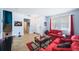 Living room with red couches, coffee table, and view of staircase at 11932 Old Glory Dr, Orlando, FL 32837