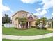 Two-story house with landscaping and palm trees at 11932 Old Glory Dr, Orlando, FL 32837