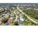 Aerial view of homes situated near a roadway and a wooded area at 17 S Flag Ct, Kissimmee, FL 34759