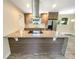 Modern kitchen island with granite countertop and stainless steel appliances at 619 Saint Lucie Ln, Orlando, FL 32807