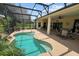 Inviting kidney-shaped pool with screened enclosure and patio area at 4423 Nottoway Dr, Leesburg, FL 34748
