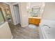 Main bathroom features a vanity, shower, and soaking tub at 4423 Nottoway Dr, Leesburg, FL 34748
