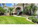 Well-maintained front yard with lush landscaping and a welcoming walkway at 4423 Nottoway Dr, Leesburg, FL 34748