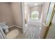 Bathroom with soaking tub, wood-look flooring, and updated fixtures at 4423 Nottoway Dr, Leesburg, FL 34748