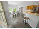 Bright dining area with glass table and view of backyard at 4423 Nottoway Dr, Leesburg, FL 34748