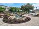 Relaxing water feature with a pond, waterfall, and lush landscaping at 4423 Nottoway Dr, Leesburg, FL 34748