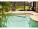 Inviting kidney shaped pool with a relaxing patio area at 4423 Nottoway Dr, Leesburg, FL 34748
