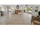 Bright living room with vinyl flooring, sliding doors to lanai, and pool view at 4423 Nottoway Dr, Leesburg, FL 34748