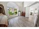 Home office with large window, built-in shelving and wood-look flooring at 4423 Nottoway Dr, Leesburg, FL 34748