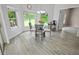 Bright dining area with glass table and view of backyard at 4423 Nottoway Dr, Leesburg, FL 34748