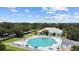 Aerial view of community pool with people enjoying a water aerobics class at 4423 Nottoway Dr, Leesburg, FL 34748