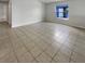 Spacious living room featuring tile flooring and a view of the backyard at 6516 Viewpoint Ct, Orlando, FL 32810