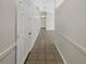 Clean hallway with tile flooring and white doors at 6516 Viewpoint Ct, Orlando, FL 32810