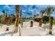 Community pool with a sandy beach area and relaxing hammocks at 3141 Paradox Cir # 306, Kissimmee, FL 34746