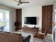 Living room with wood accent wall, flat-screen TV, and comfortable seating at 3141 Paradox Cir # 306, Kissimmee, FL 34746
