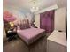 Main bedroom with a gold bed frame and purple bedding at 3141 Paradox Cir # 306, Kissimmee, FL 34746