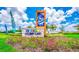 Storey Lake community entrance with landscaping and signage at 3141 Paradox Cir # 306, Kissimmee, FL 34746