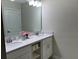 Double vanity bathroom with white cabinets and a large mirror at 3141 Paradox Cir # 306, Kissimmee, FL 34746