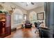 Spacious home office features wood floors, built-in shelving, and large windows at 12203 Pasha Ln, Orlando, FL 32827