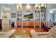 Spacious living room with hardwood floors, built-in shelving, and access to a patio at 12203 Pasha Ln, Orlando, FL 32827