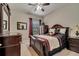 Well-lit bedroom with a queen-size bed and ceiling fan at 12203 Pasha Ln, Orlando, FL 32827