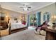 Spacious Primary bedroom with a king-size bed and access to a private patio at 12203 Pasha Ln, Orlando, FL 32827
