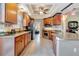 Modern kitchen with granite countertops, wood cabinets, and stainless steel appliances at 12203 Pasha Ln, Orlando, FL 32827