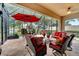 Relaxing screened patio with seating and red umbrella at 12203 Pasha Ln, Orlando, FL 32827