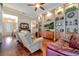 Relaxing living room with hardwood floors, built-in shelving, and a large TV at 12203 Pasha Ln, Orlando, FL 32827