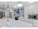 Renovated kitchen boasts white cabinets, quartz countertops and stainless steel appliances at 1055 Kensington Park Dr # 212, Altamonte Springs, FL 32714