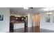 Open concept kitchen with island, stainless steel appliances, and dark cabinets at 2652 Carrickton Cir, Orlando, FL 32824