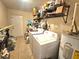 Laundry room with washer, dryer, and storage shelving at 3804 Janie Ct, Orlando, FL 32822