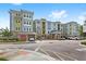 Modern apartment building with parking and landscaping at 7573 Laureate Blvd # 1301, Orlando, FL 32827