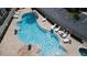 Relaxing community pool with lounge chairs at 7574 Sunny Dreams Ln, Kissimmee, FL 34747