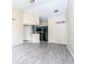 Open concept living room and kitchen with grey tile floors at 1932 Lake Atriums Cir # 86, Orlando, FL 32839
