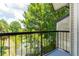 Balcony view overlooking a serene lake and lush trees at 1932 Lake Atriums Cir # 86, Orlando, FL 32839