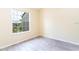 Bedroom with large window overlooking pond view and grey tile floors at 1932 Lake Atriums Cir # 86, Orlando, FL 32839