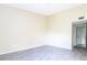 Spacious bedroom with gray tile flooring and access to hallway at 1932 Lake Atriums Cir # 86, Orlando, FL 32839