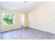 Bright bedroom with gray tile floor and large window at 1932 Lake Atriums Cir # 86, Orlando, FL 32839