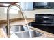 Modern kitchen sink and faucet with granite countertop at 1932 Lake Atriums Cir # 86, Orlando, FL 32839
